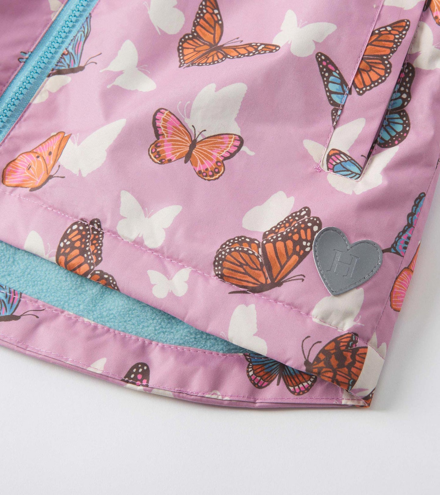 Lightweight pink raincoat featuring colorful butterfly patterns and a soft blue lining. Ideal for rainy days.