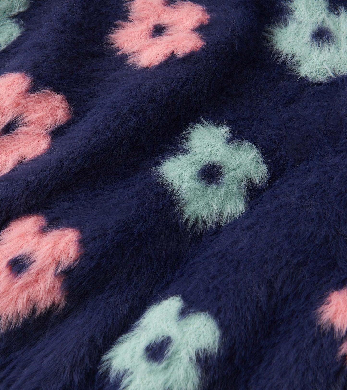 Navy open cardigan featuring soft, fuzzy flowers in pink and mint green, ideal for layering in cooler weather.