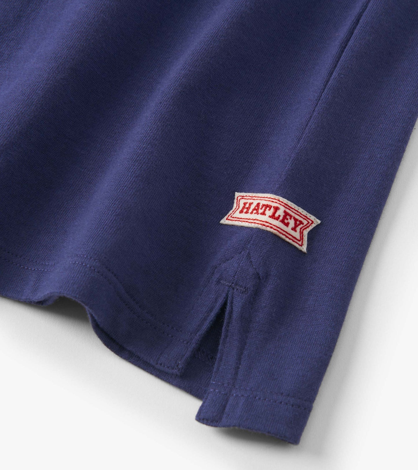 Boys' blue rugby polo featuring stripes and a side vent, made from soft cotton fabric.