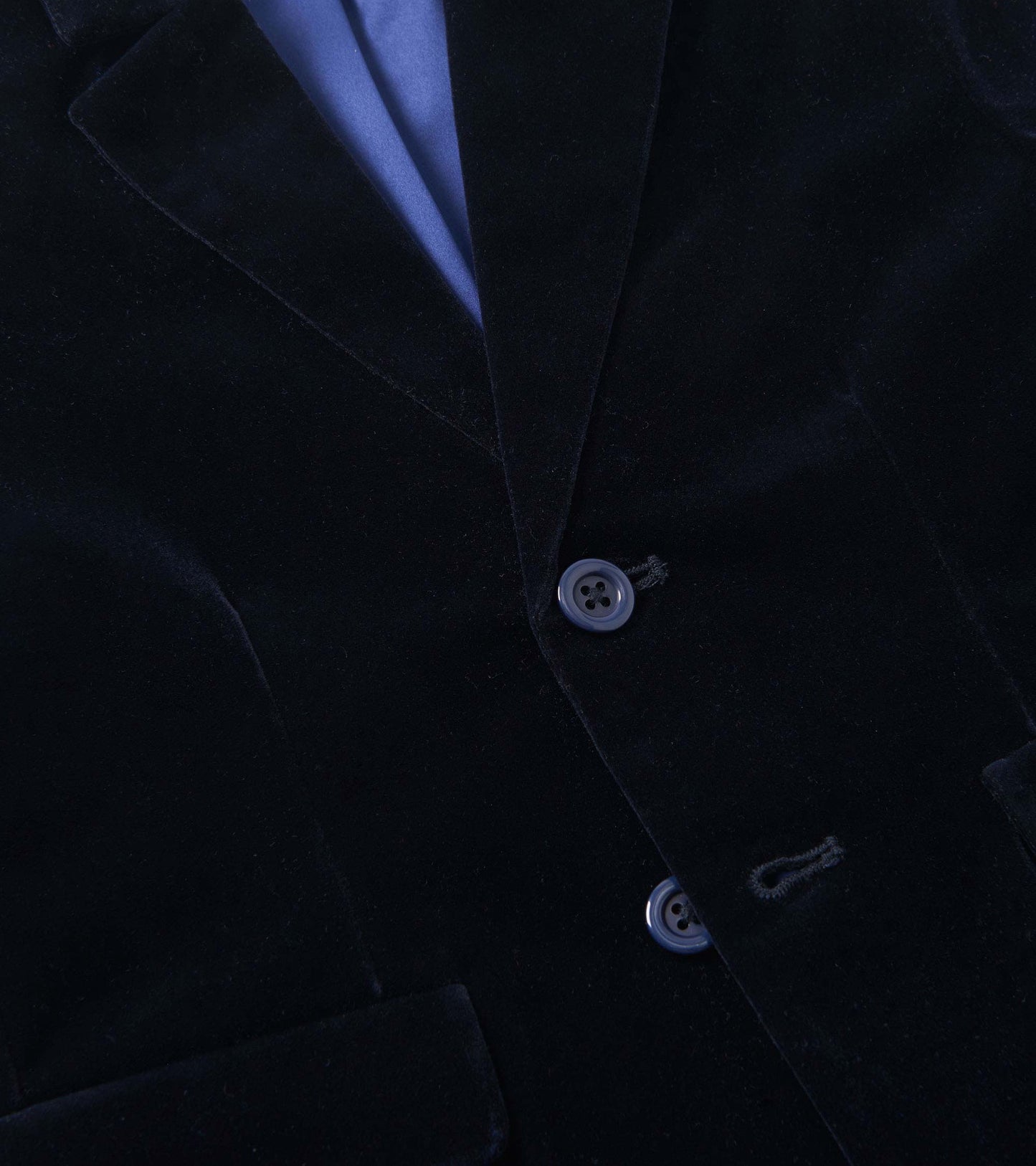 Navy velveteen holiday blazer with two buttons and a notched collar, featuring a blue satin lining.