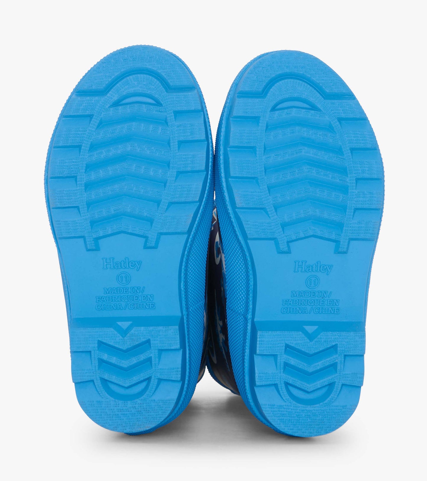 Blue rubber wellies with a textured sole, featuring a colorful dinosaur pattern for kids.