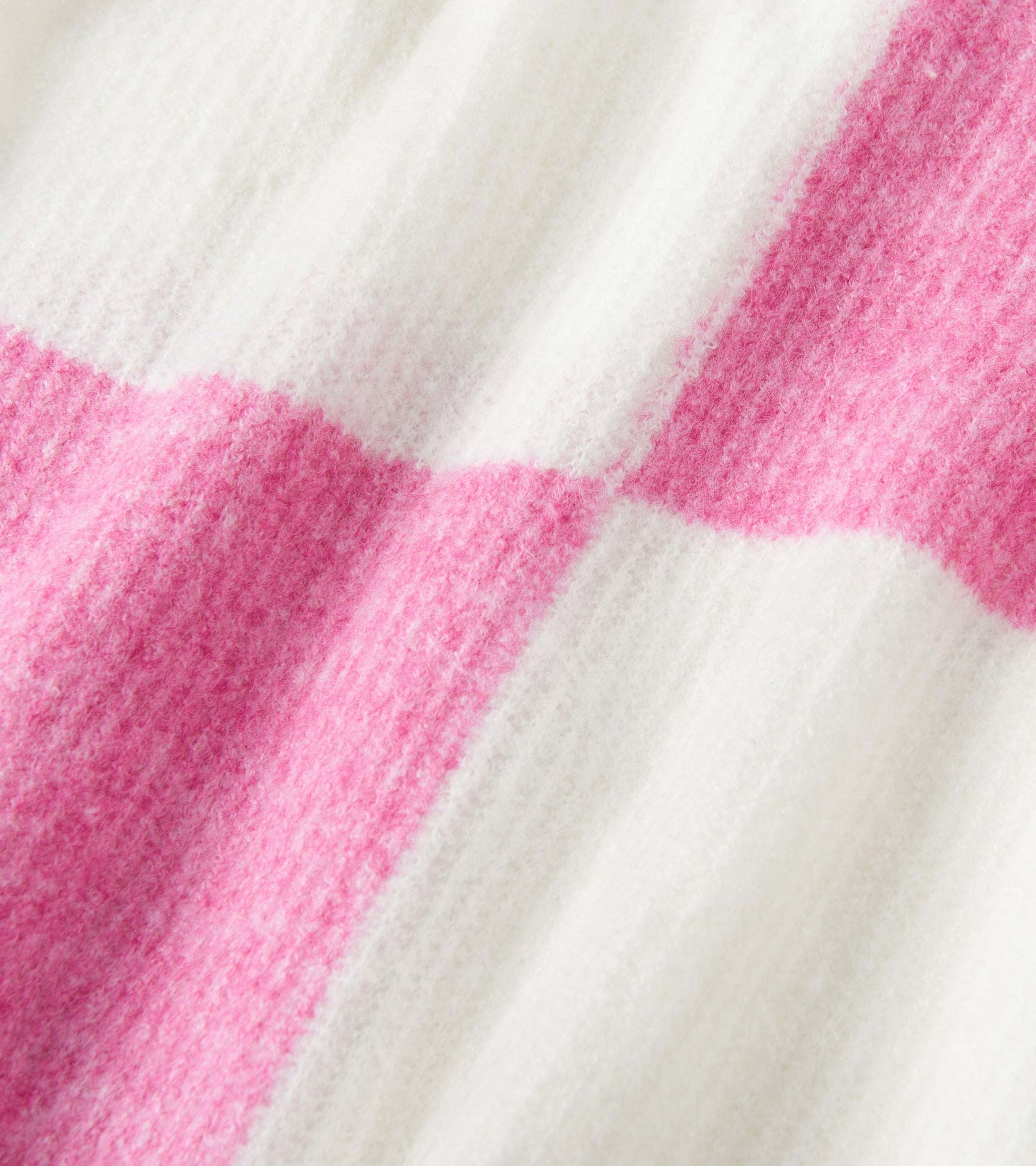 Pink and white check pattern drop shoulder sweater, featuring a soft, textured knit material.