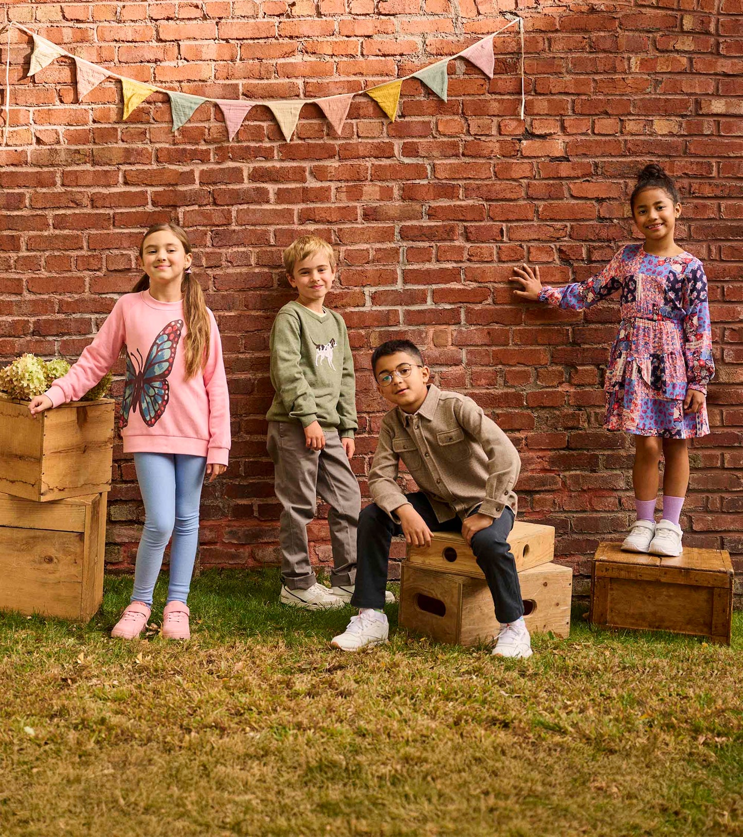 Pink slouchy pullover featuring a butterfly graphic, paired with light blue leggings and pink shoes, worn by a girl.