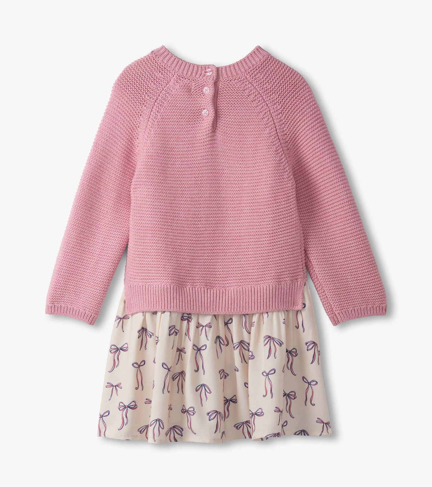 Pink mixed media sweater dress with a textured top and a skirt featuring a bow pattern. Back view with button closure.