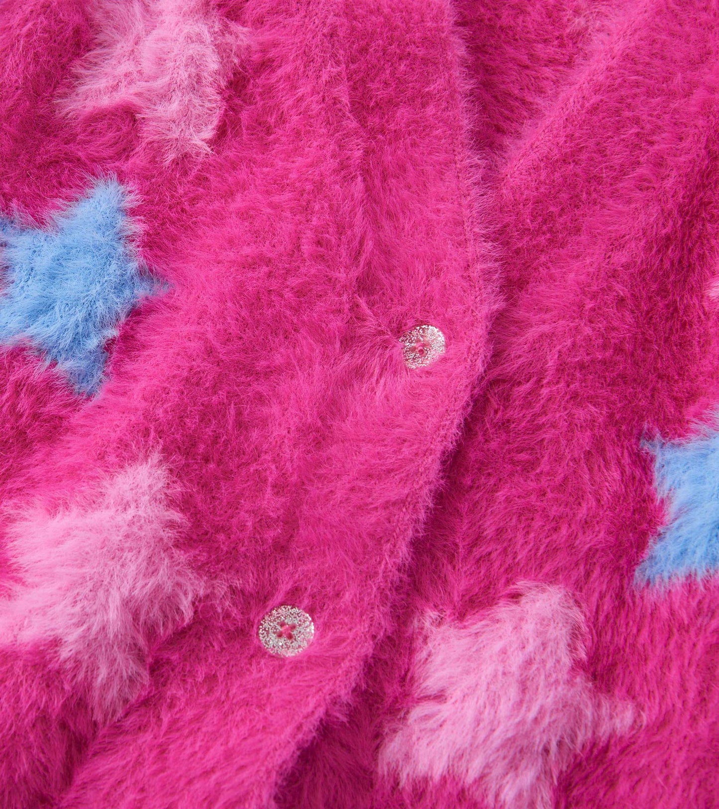 Fuzzy pink cardigan featuring colorful star patterns and decorative buttons. Ideal for layering in cooler weather.