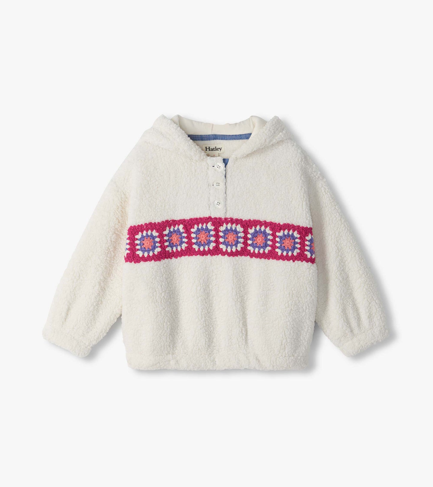 Cream fuzzy pullover with collar, partial button placket, and pink, purple, and white crochet band across chest
