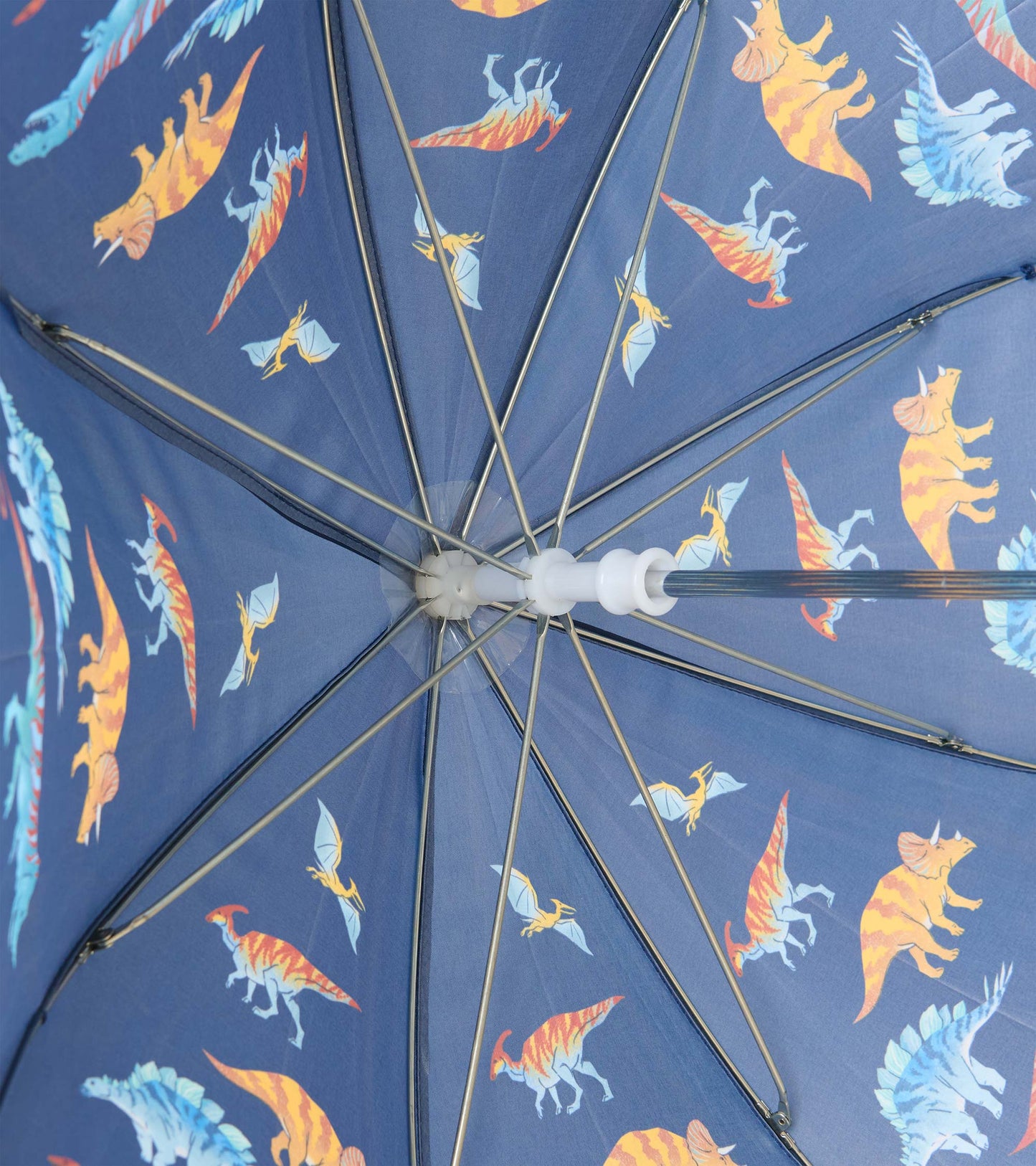 Interior close-up of navy umbrella showing metal ribs and colorful dinosaur print