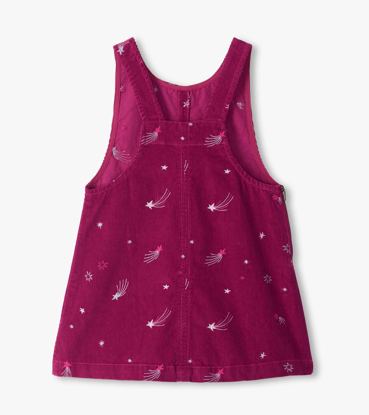 Back of pink pinafore dress with cross straps and embroidered star and shooting star pattern