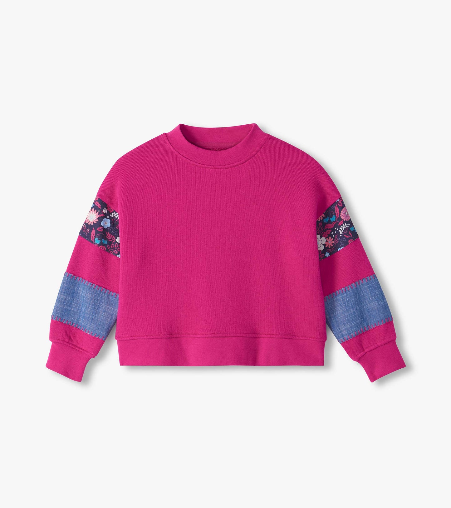 Bright pink pullover with floral shoulder panels, blue sleeve patches, and ribbed cuffs and hem