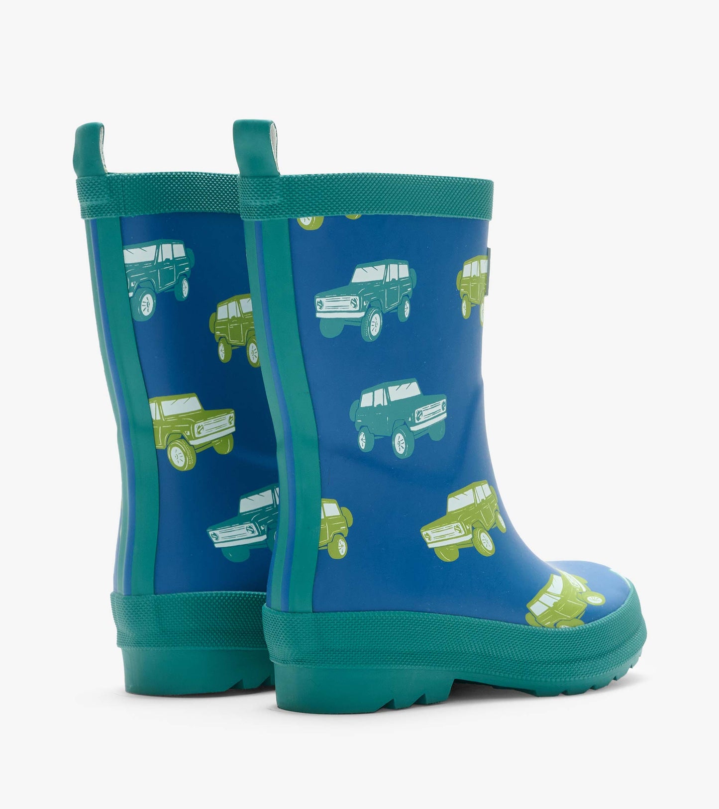 Pair of blue kids rain boots with green trim and vintage truck print, back angled view