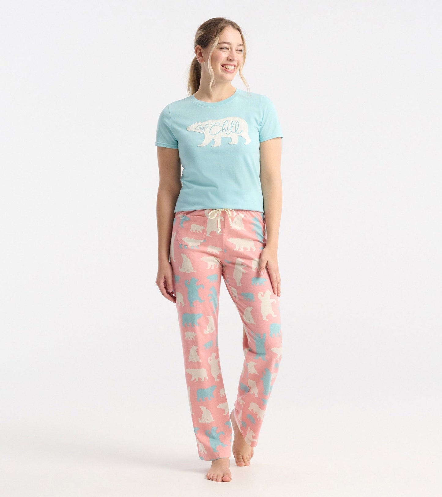 Women's pink cotton pyjama pants featuring a polar bear pattern and an elastic waistband with drawstring.