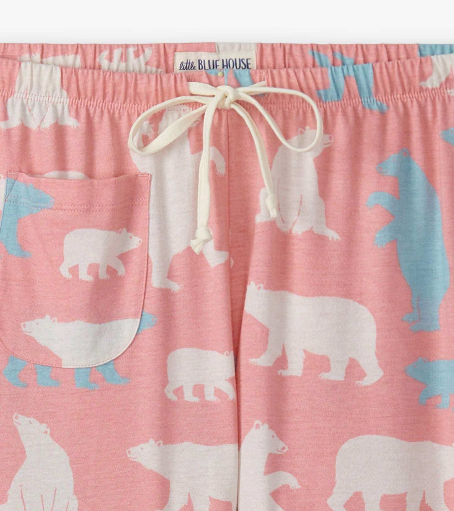Pink cotton pyjama pants featuring a polar bear pattern in white and blue, with an elastic waistband and side pocket.