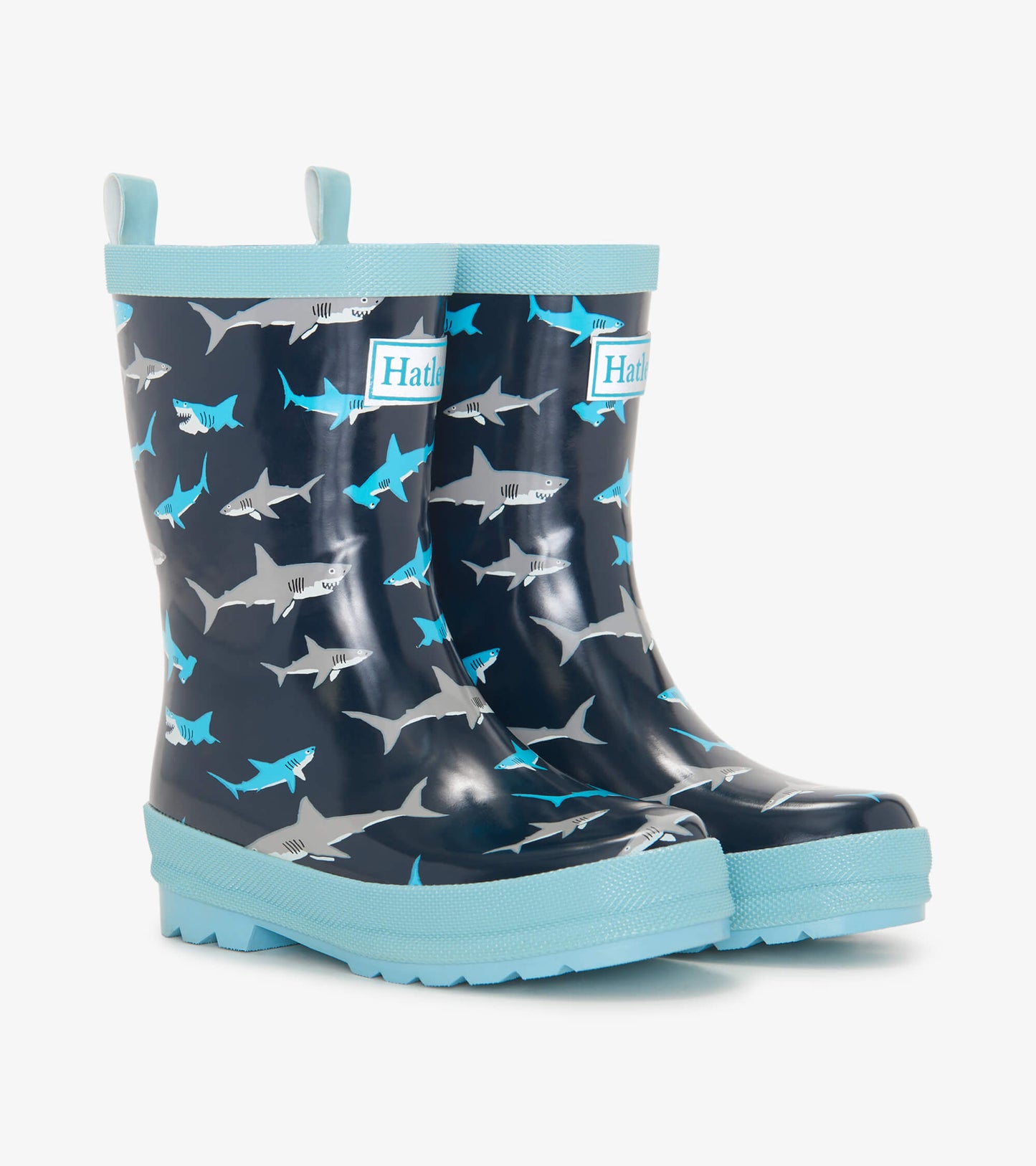 Navy blue wellies featuring a shark pattern, with a light blue sole and trim, designed for kids.