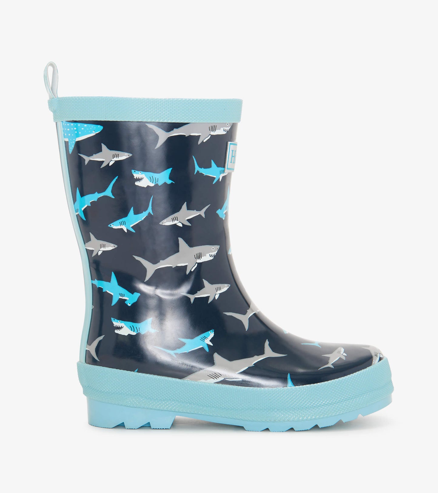 Navy blue wellies featuring a playful shark pattern, with a light blue trim and textured sole for grip.