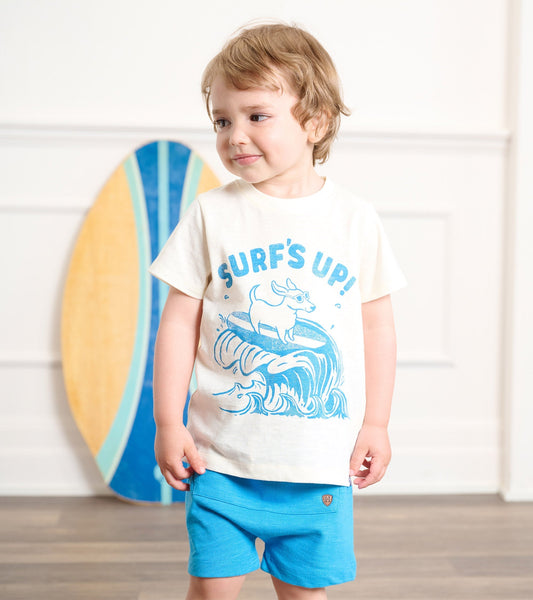 Cream graphic tee featuring a blue surf design, paired with bright blue shorts, suitable for baby and toddler boys.