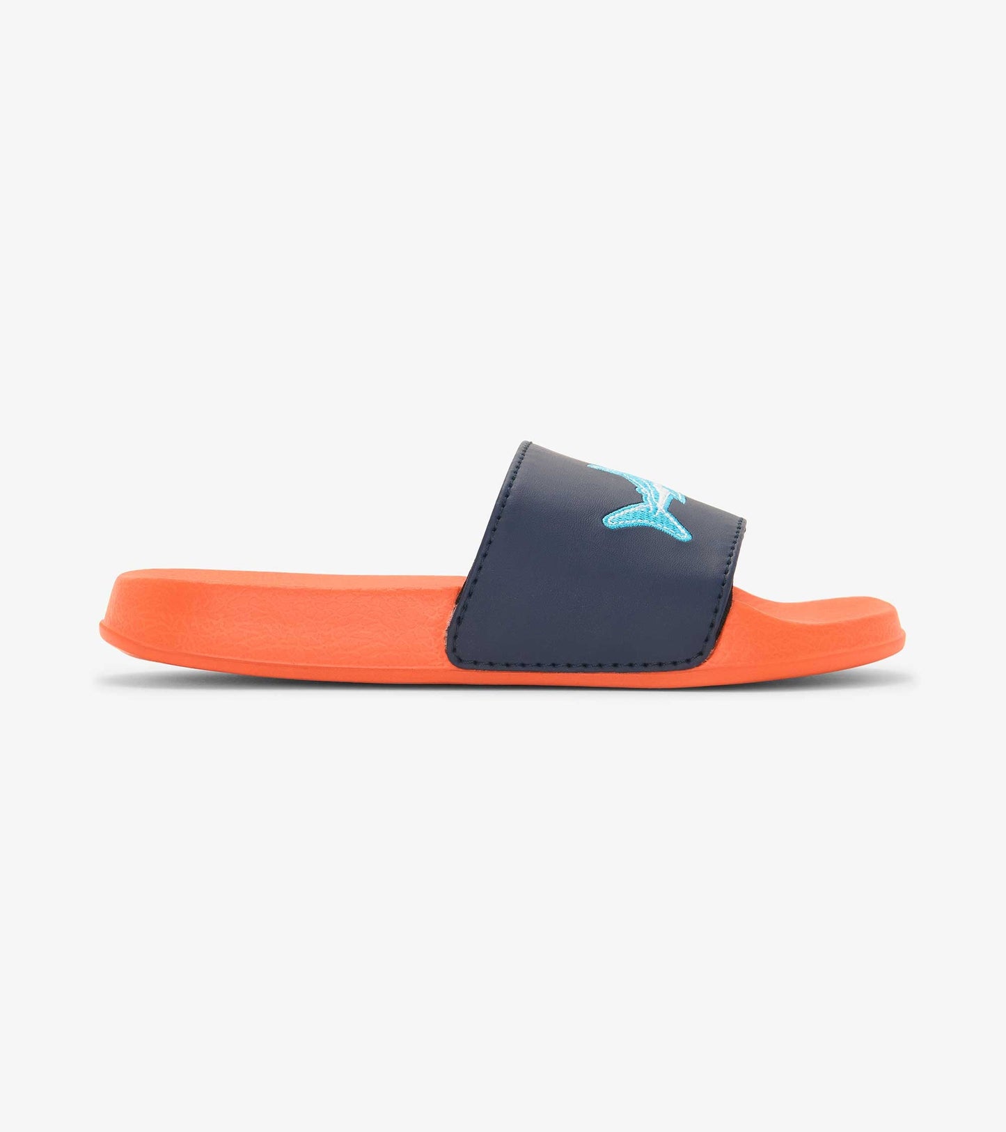 Navy blue slide sandals with an orange sole and shark design on the strap, suitable for boys.