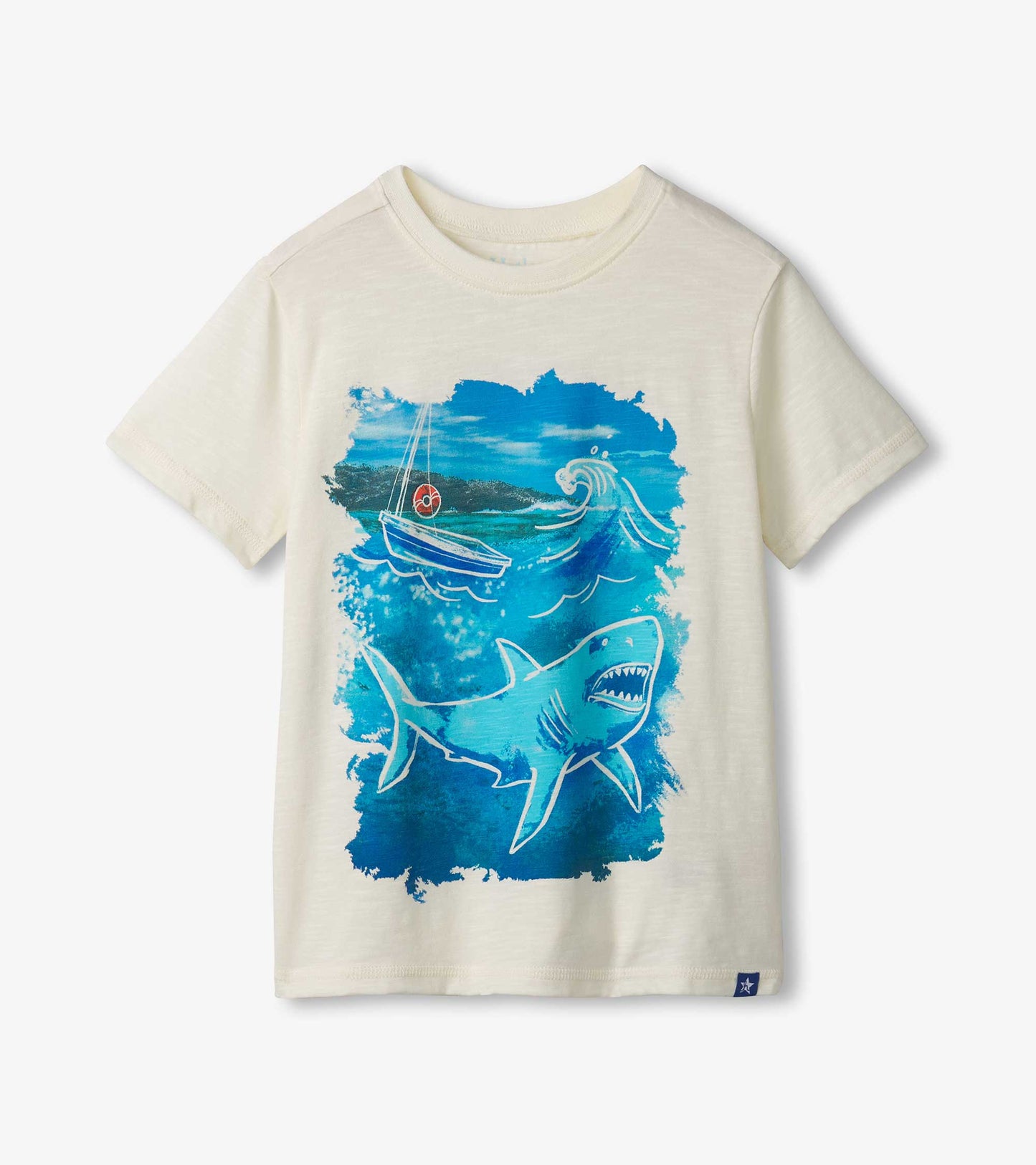 Cream short-sleeve tee featuring a blue shark graphic and a boat in ocean waves.