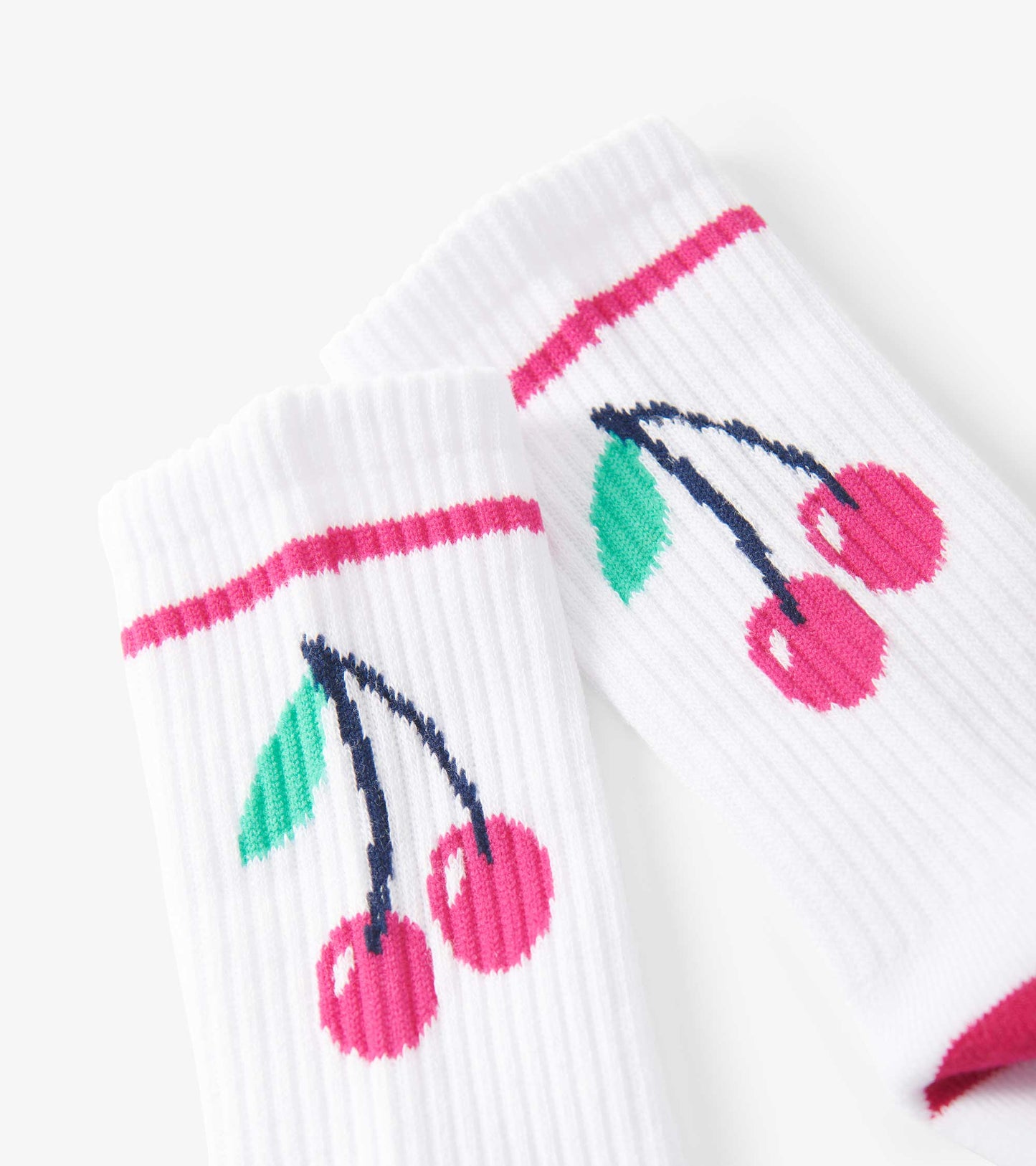 White tube socks featuring a cherry pattern with pink and green accents, suitable for kids ages 2-12.