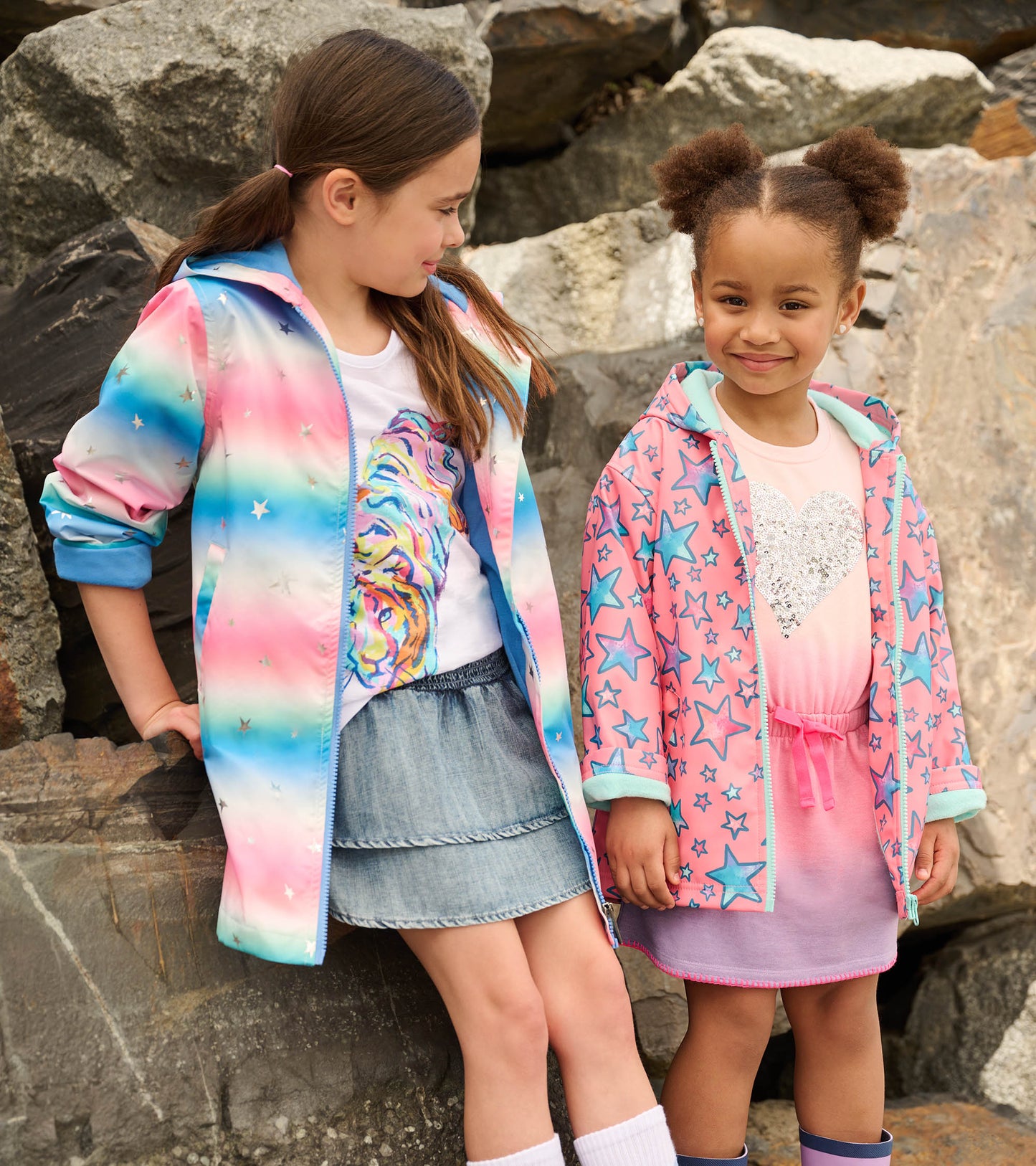 Colorful zip-up raincoat featuring watercolor patterns and star designs, suitable for girls.