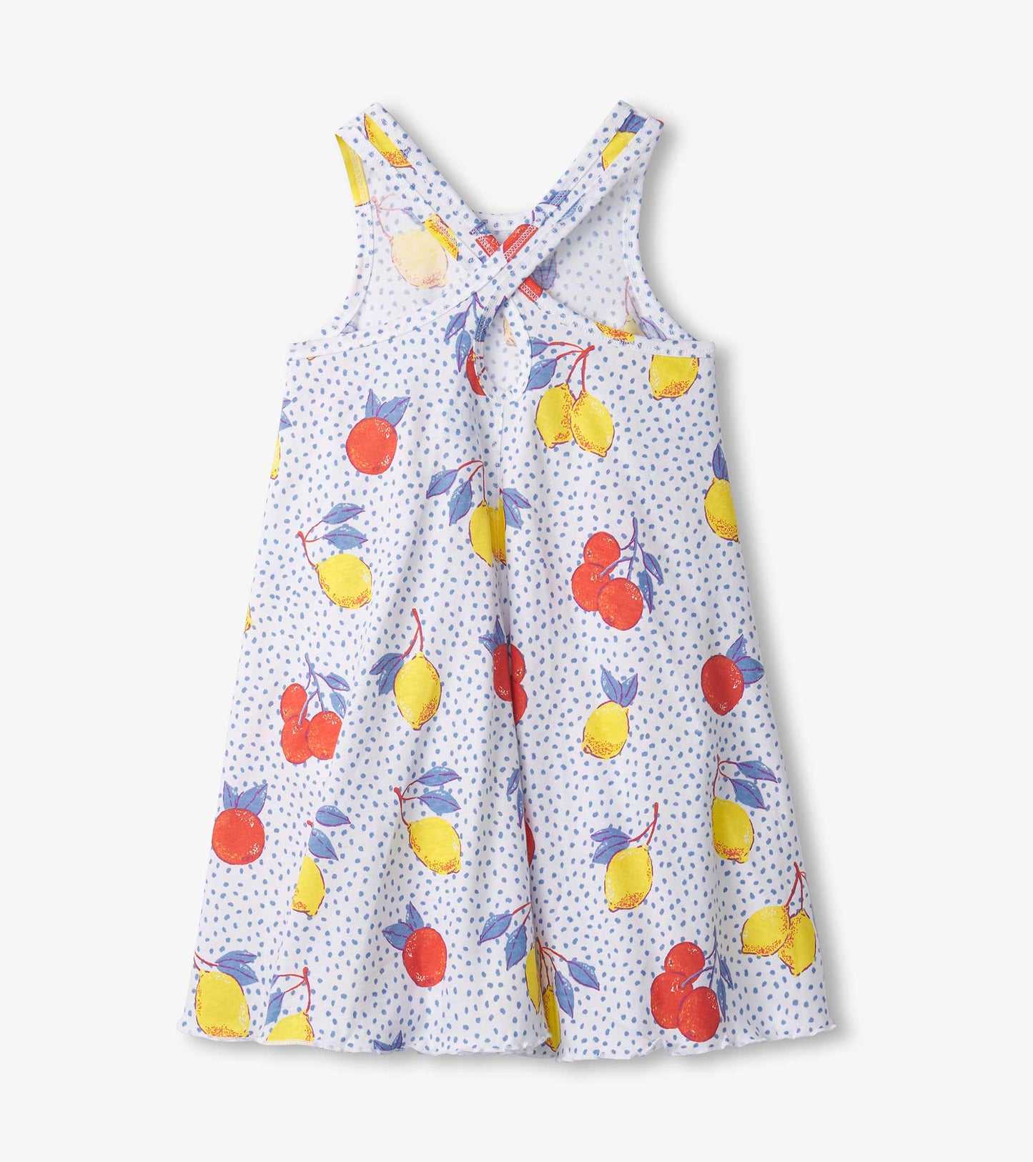 Light blue trapeze dress with a fruit pattern featuring lemons, cherries, and oranges, designed with crisscross straps.