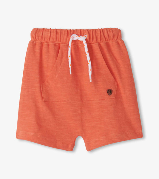 Coral kangaroo shorts with a drawstring waist and front pocket, suitable for baby and toddler girls.