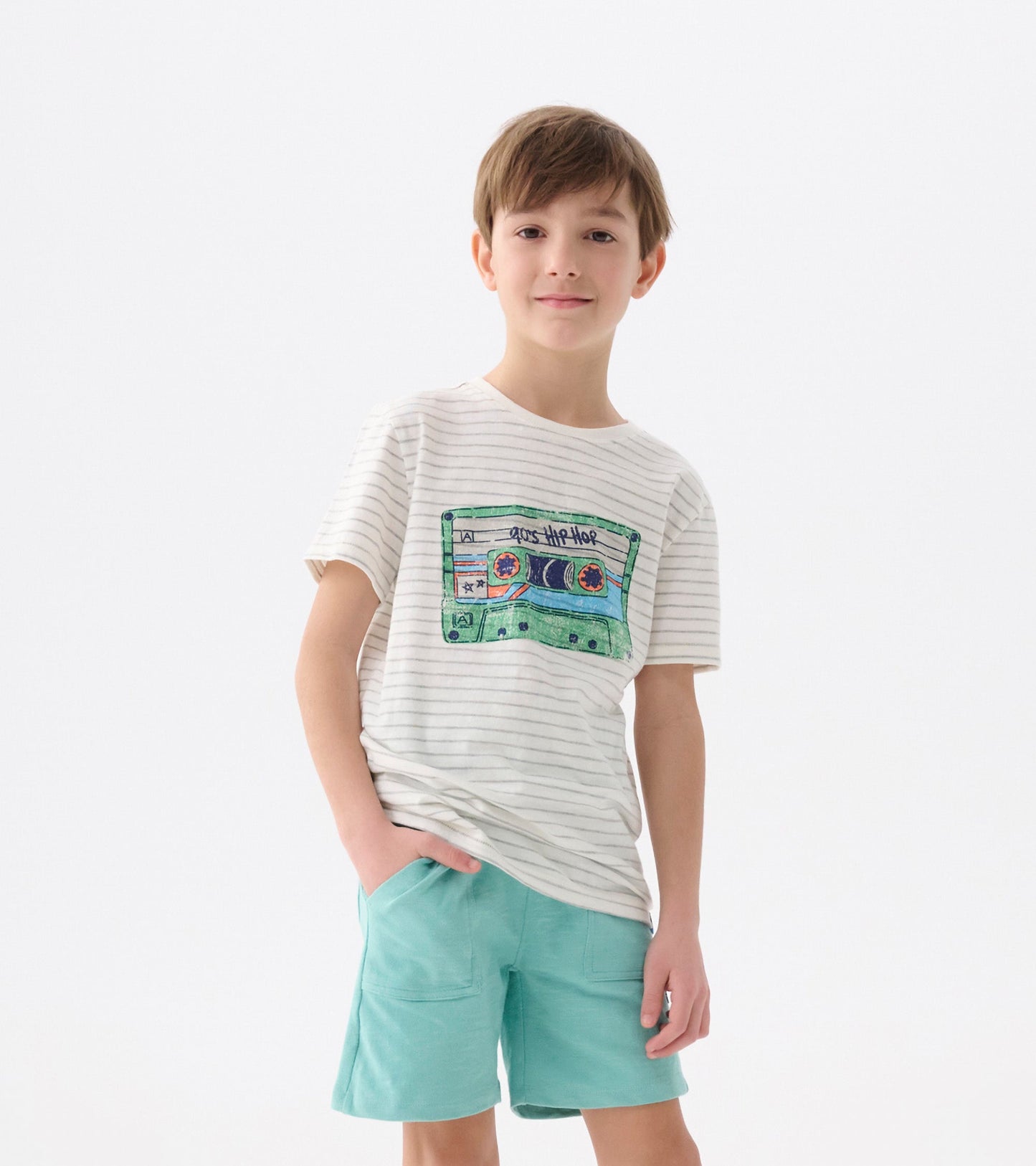 Striped short-sleeve tee featuring a colorful cassette graphic, paired with light blue shorts.