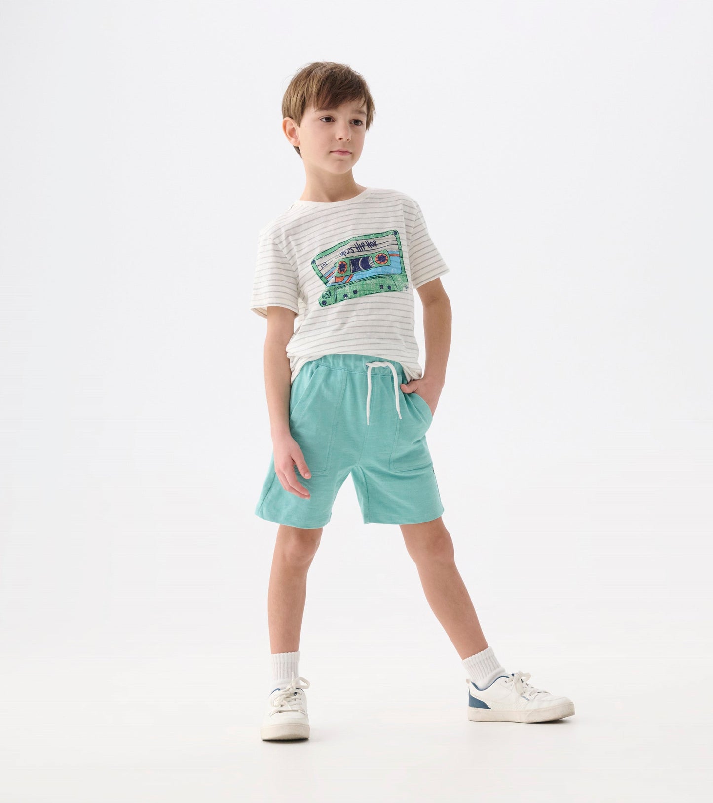 Boys' short-sleeve tee with a striped pattern and a colorful cassette graphic, paired with light blue shorts.