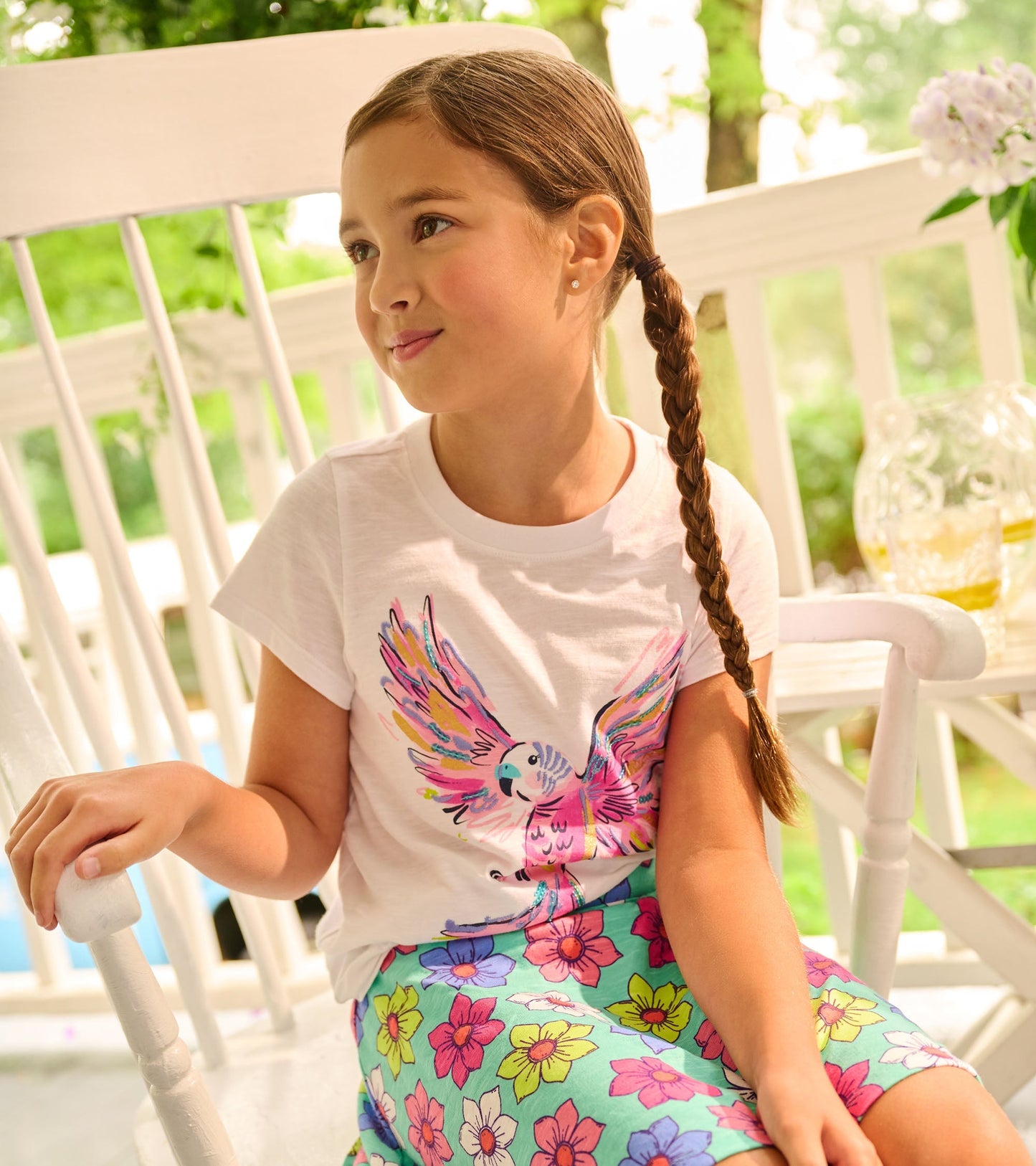 Colorful floral skort with a vibrant pattern, paired with a white short-sleeve shirt featuring a bird design.
