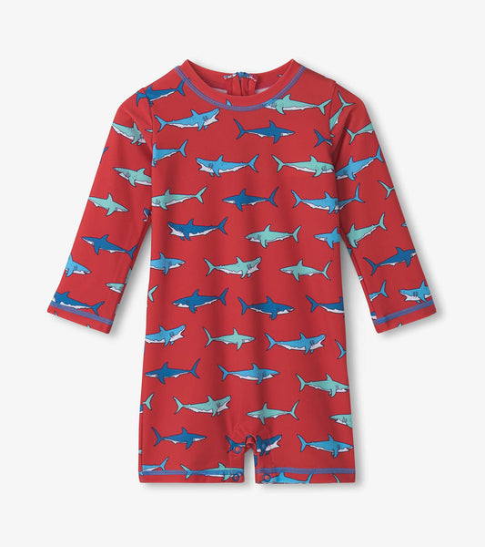 Red one-piece rashguard featuring a playful shark pattern and long sleeves, suitable for baby boys.