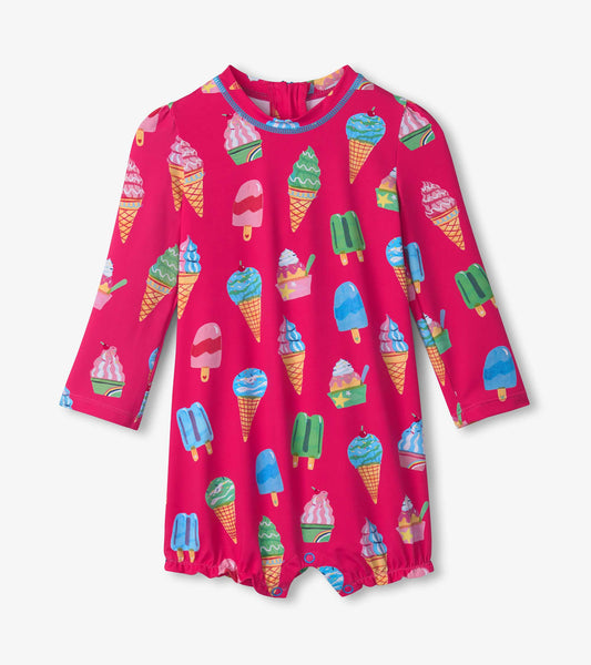 Bright pink rashguard swimsuit featuring colorful ice cream cone and popsicle patterns, designed for baby girls.