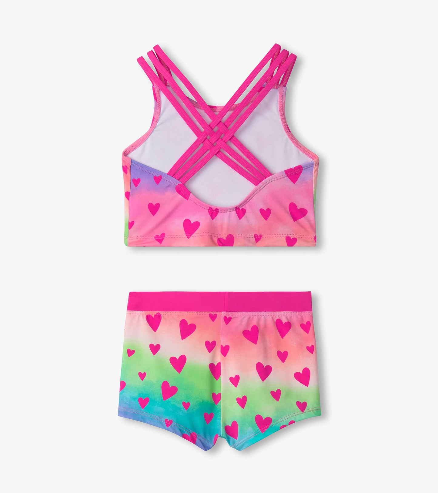 Two-piece swimsuit featuring a pink heart pattern on a gradient background, with a crisscross strap design on the top.