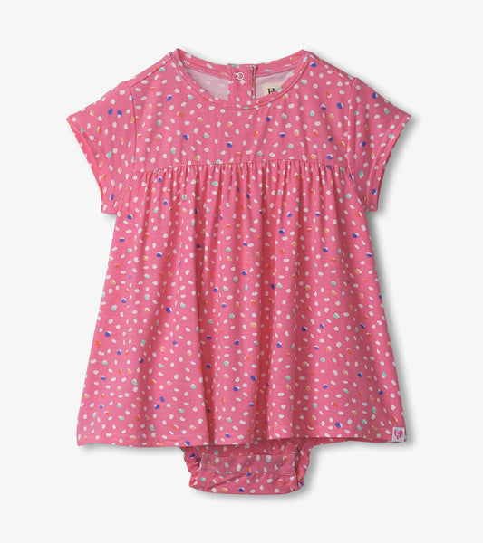 Pink one-piece dress with colorful polka dots, short sleeves, and a gathered waist, suitable for baby and toddler girls.