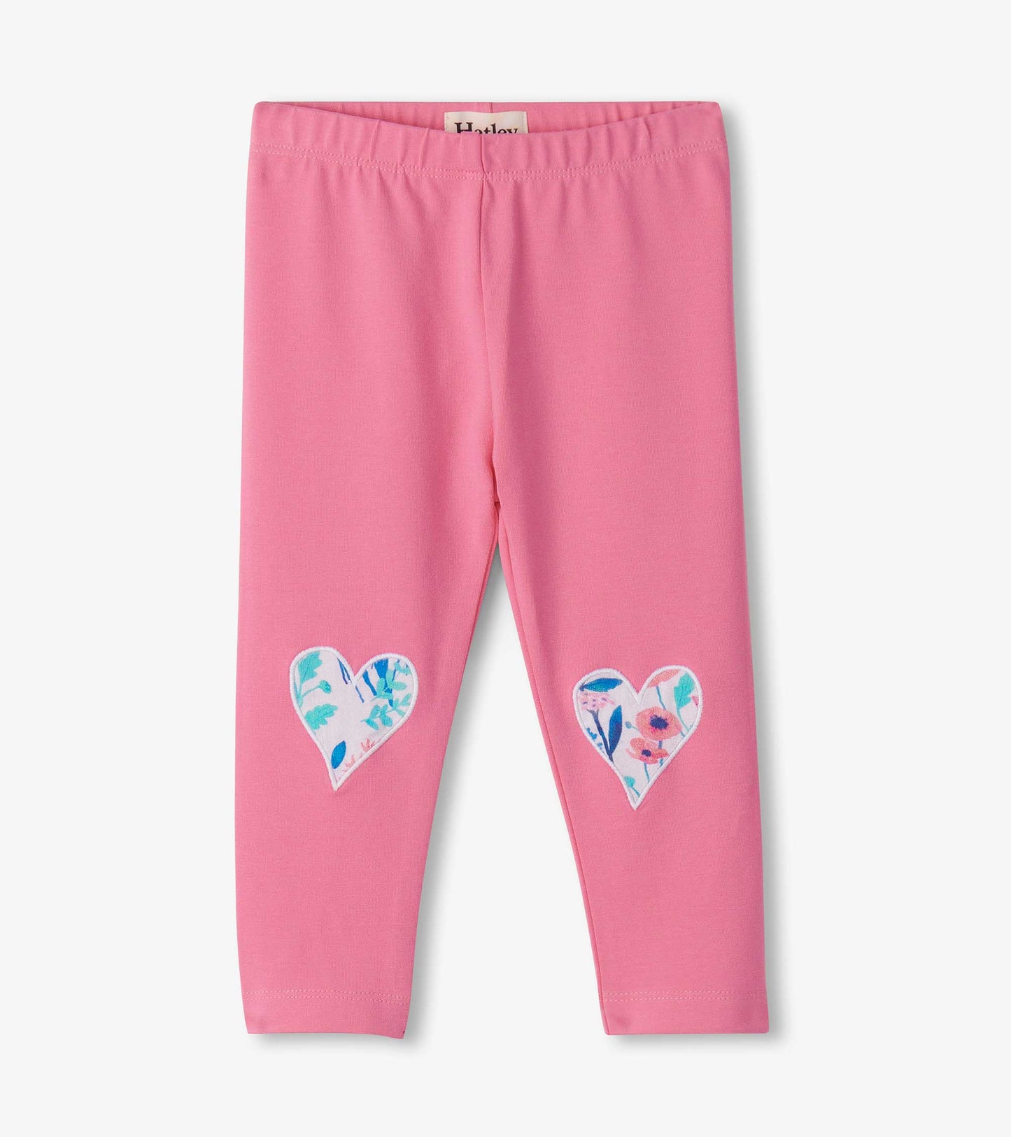 Pink leggings featuring floral heart patches on the knees, made from soft, stretchy material for comfort.