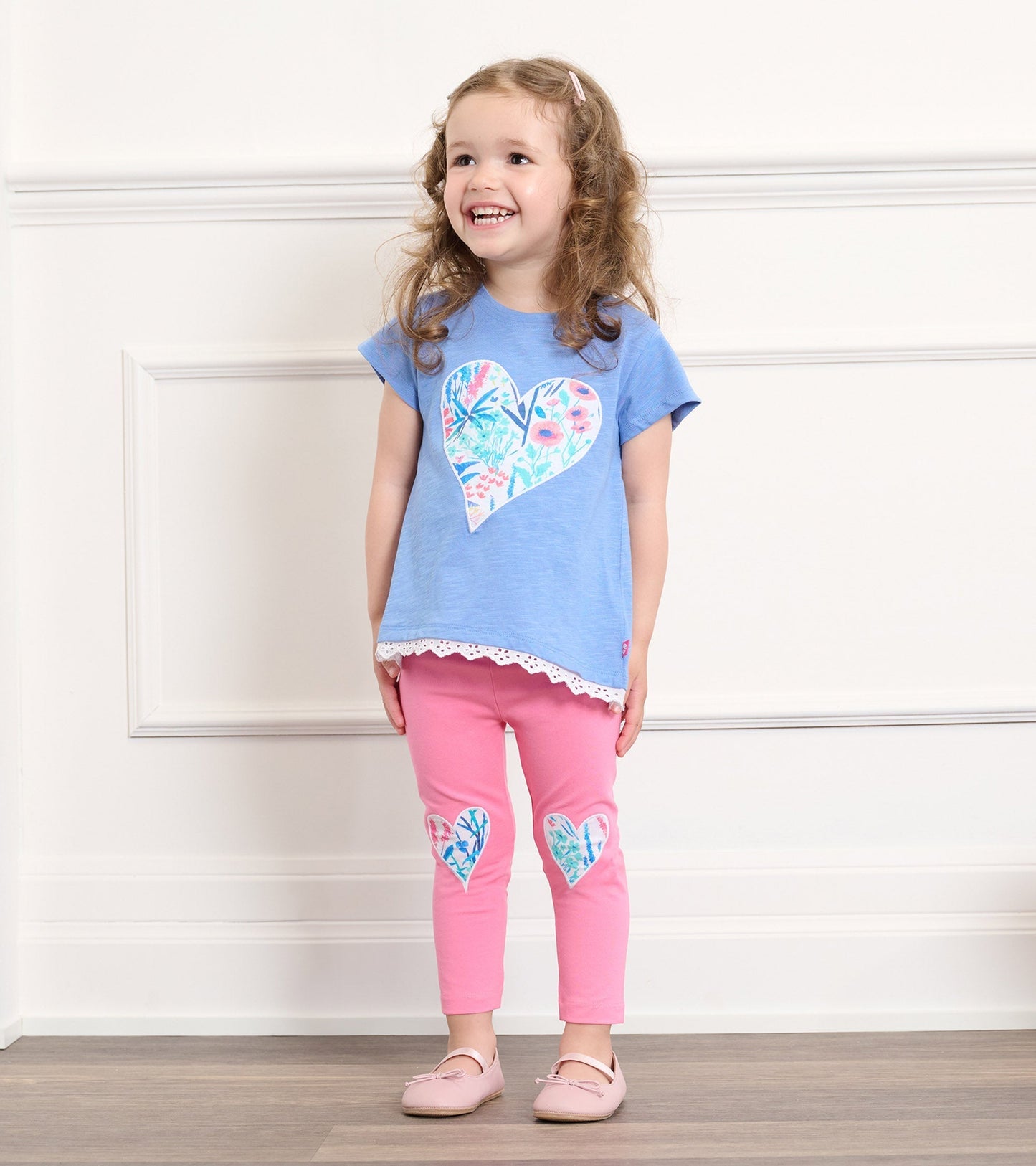 Pink leggings featuring heart-shaped floral patches, perfect for baby and toddler girls.