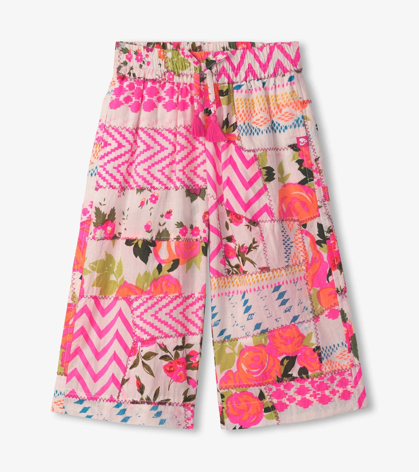 Cropped culottes featuring a vibrant floral and geometric patchwork pattern in pink, green, and yellow tones.