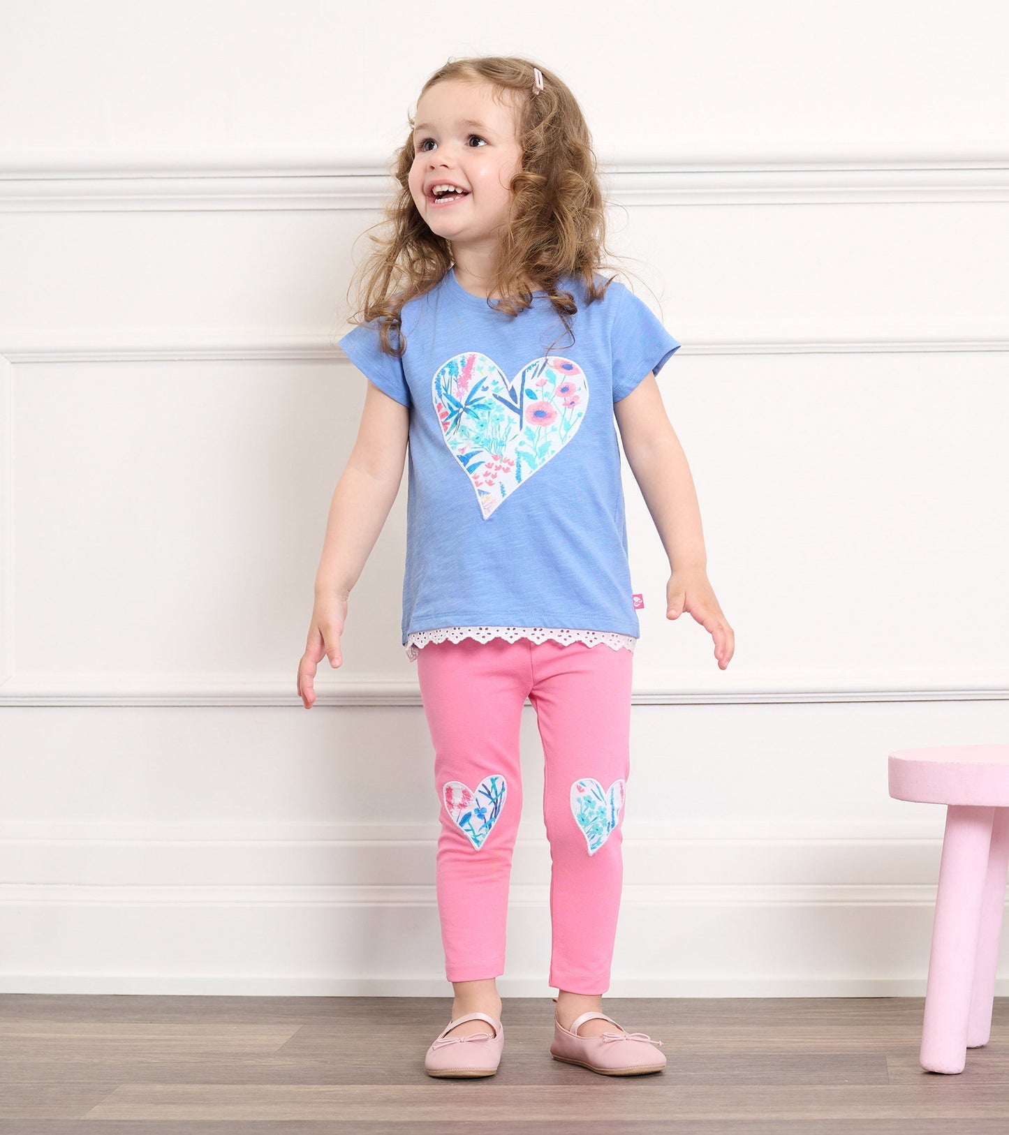 Light blue t-shirt with floral heart design and eyelet trim, paired with pink leggings featuring heart appliqués.