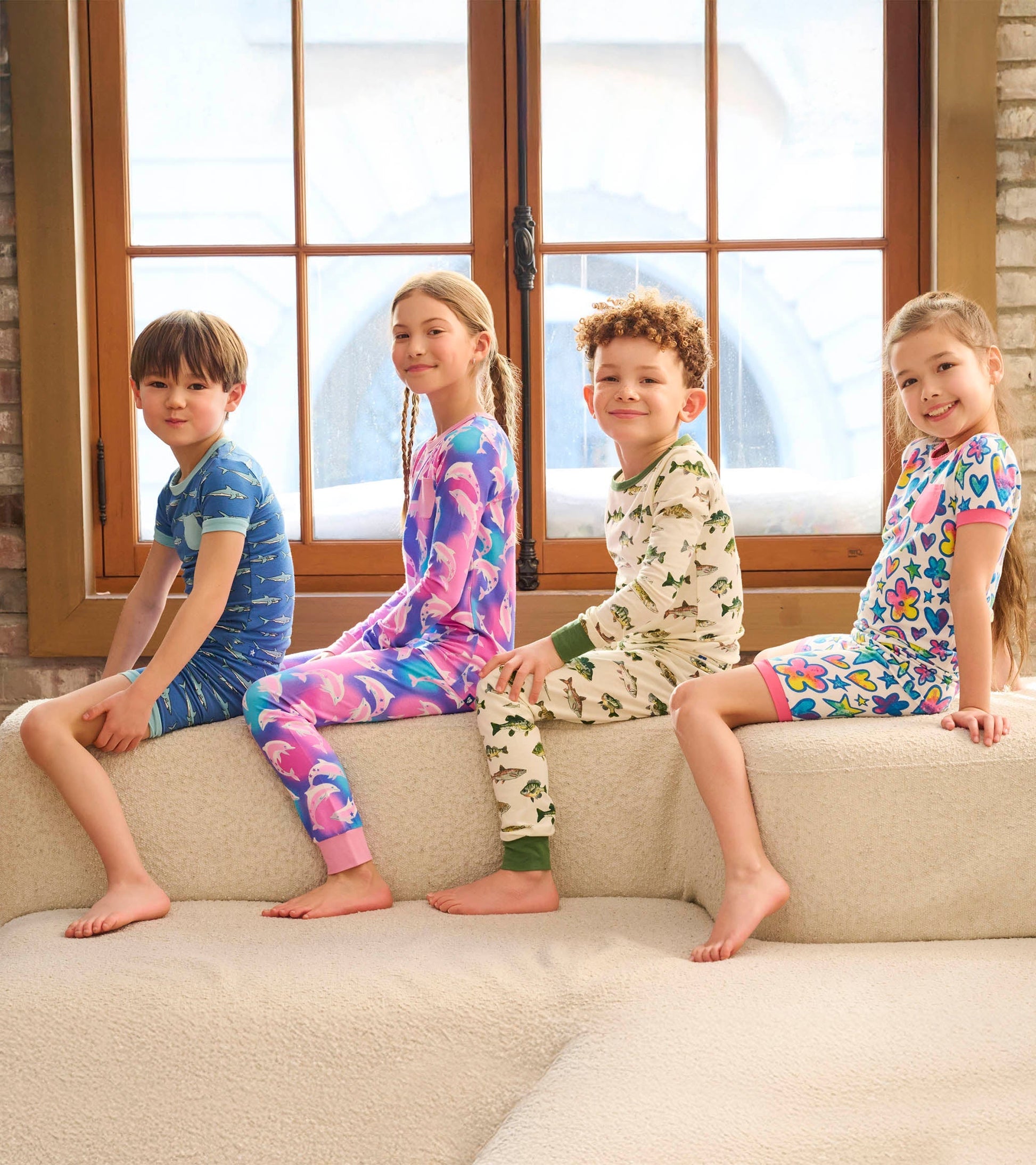 Colorful boys' pyjama set featuring fish, flowers, and playful patterns, suitable for sleepwear.