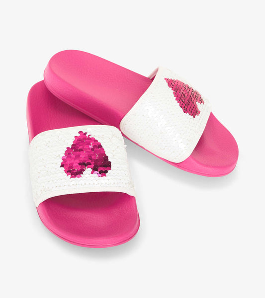 White slides with pink sequin heart designs and a pink sole, ideal for casual summer wear.