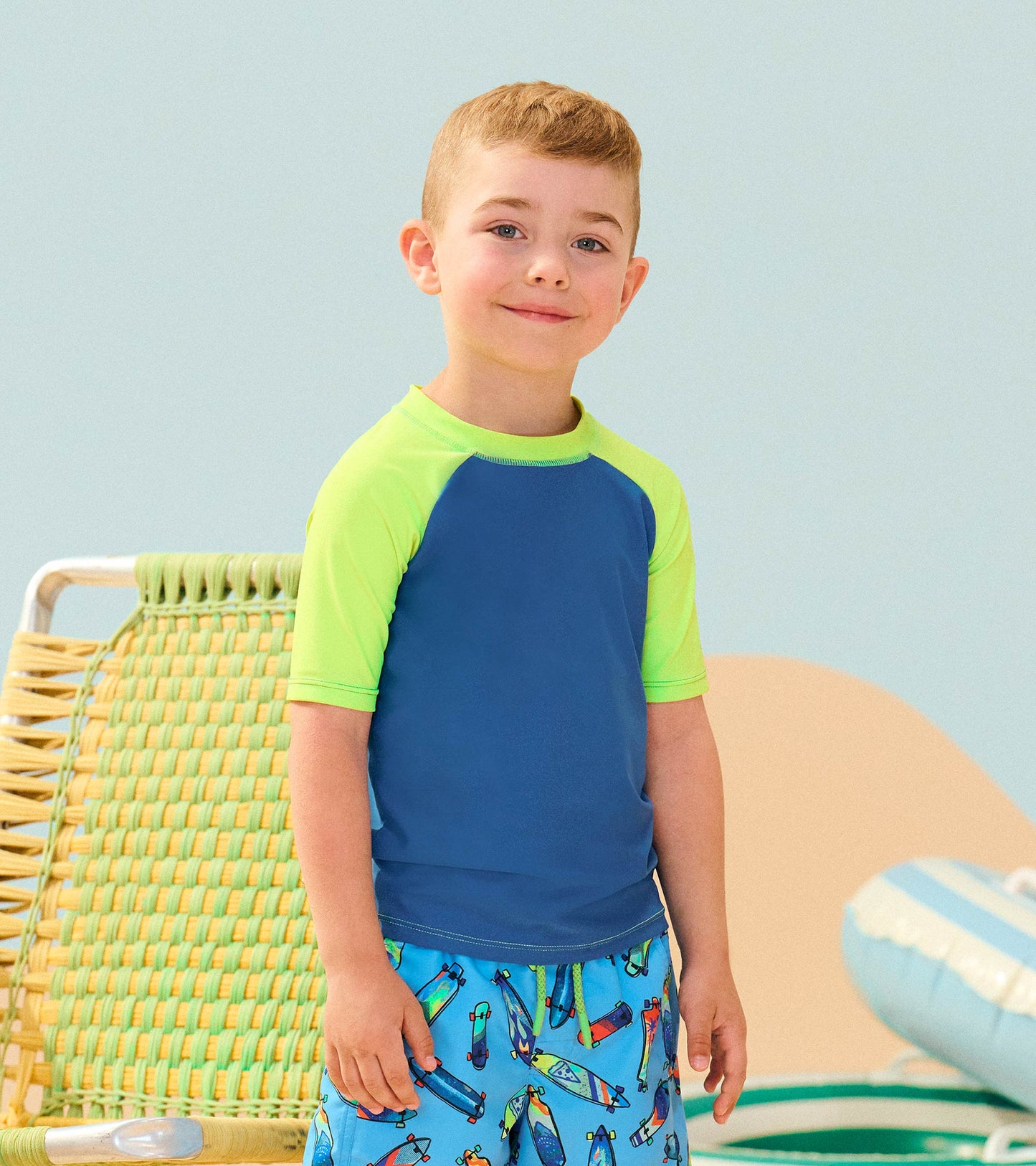Short sleeve rashguard in blue with bright green sleeves, perfect for beach or pool activities.