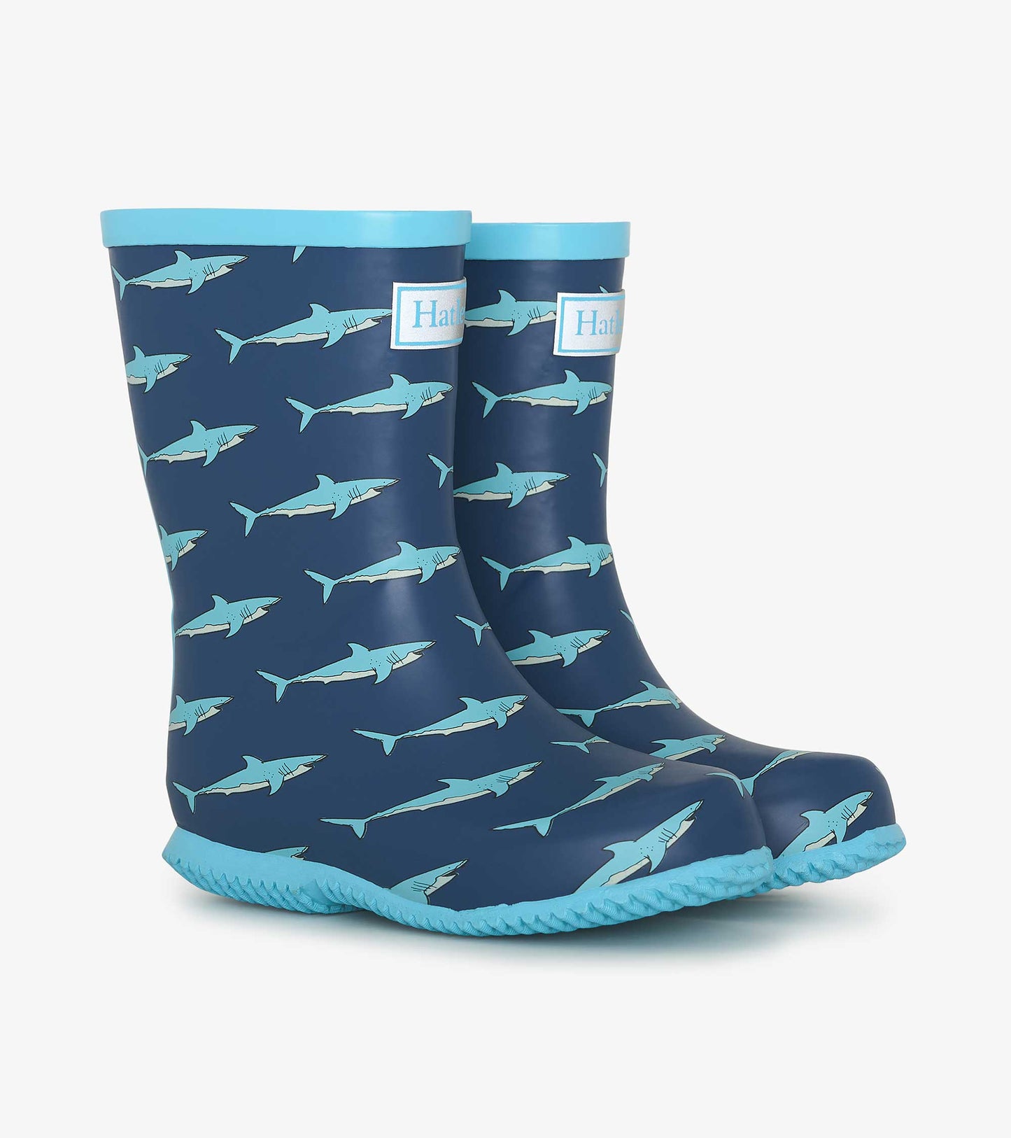 Navy blue wellies featuring a shark pattern and light blue trim, designed for kids and suitable for wet weather.