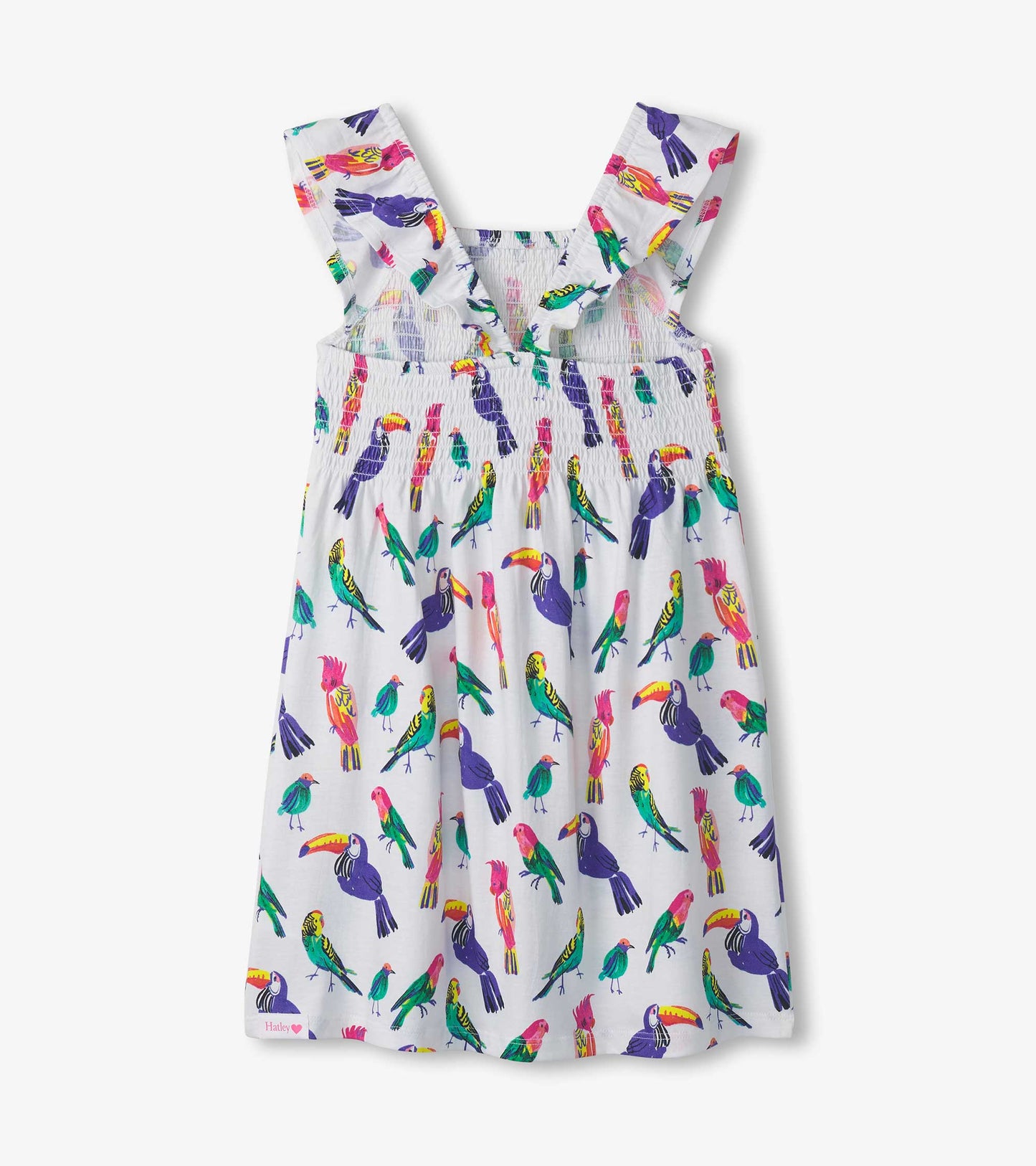 White smocked dress featuring colorful tropical bird prints and ruffled straps, suitable for warm weather wear.