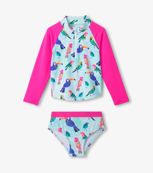Long-sleeve rashguard with tropical bird print and pink sleeves, paired with matching bikini bottoms.
