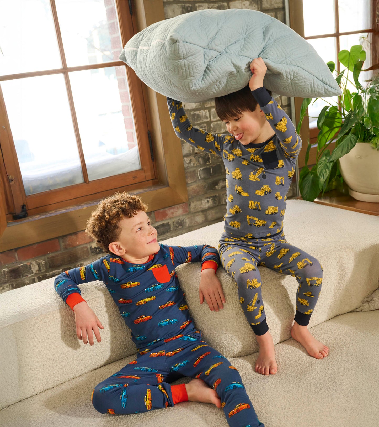 Boys' bamboo pyjama set featuring colorful sport cars and construction vehicles, designed for comfort and play.