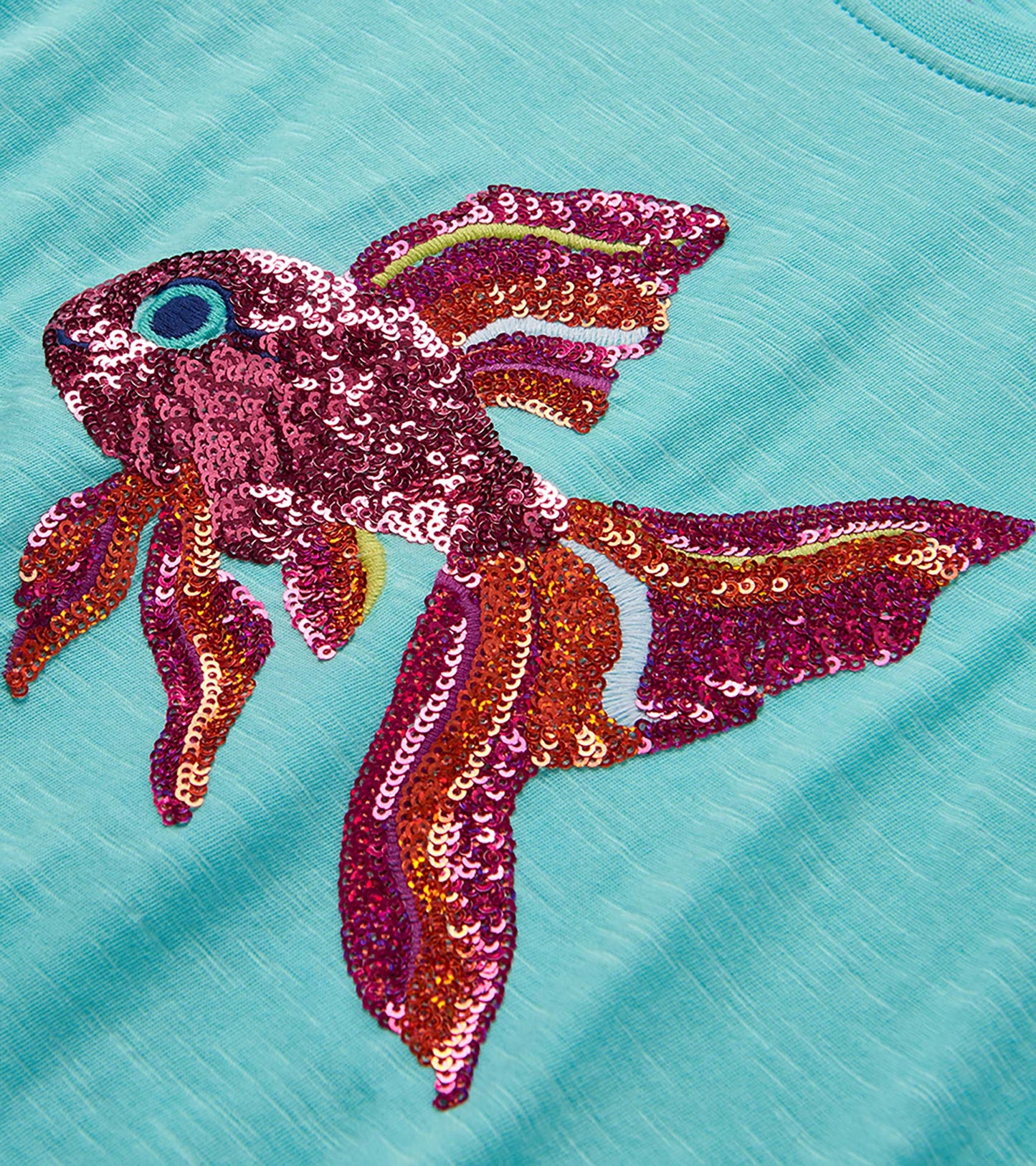 Turquoise T-shirt with large multicolor sequined tropical fish graphic on the front