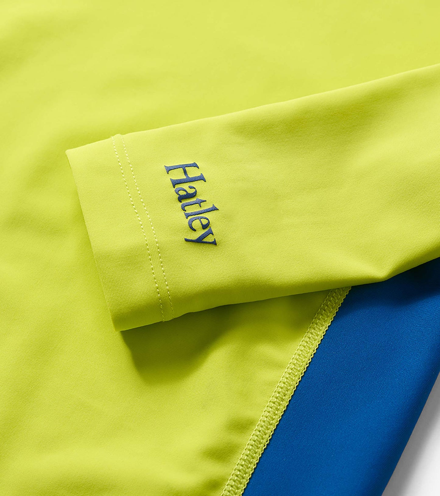 Lime and blue colorblock long sleeve rashguard with stitched cuff detail and logo print