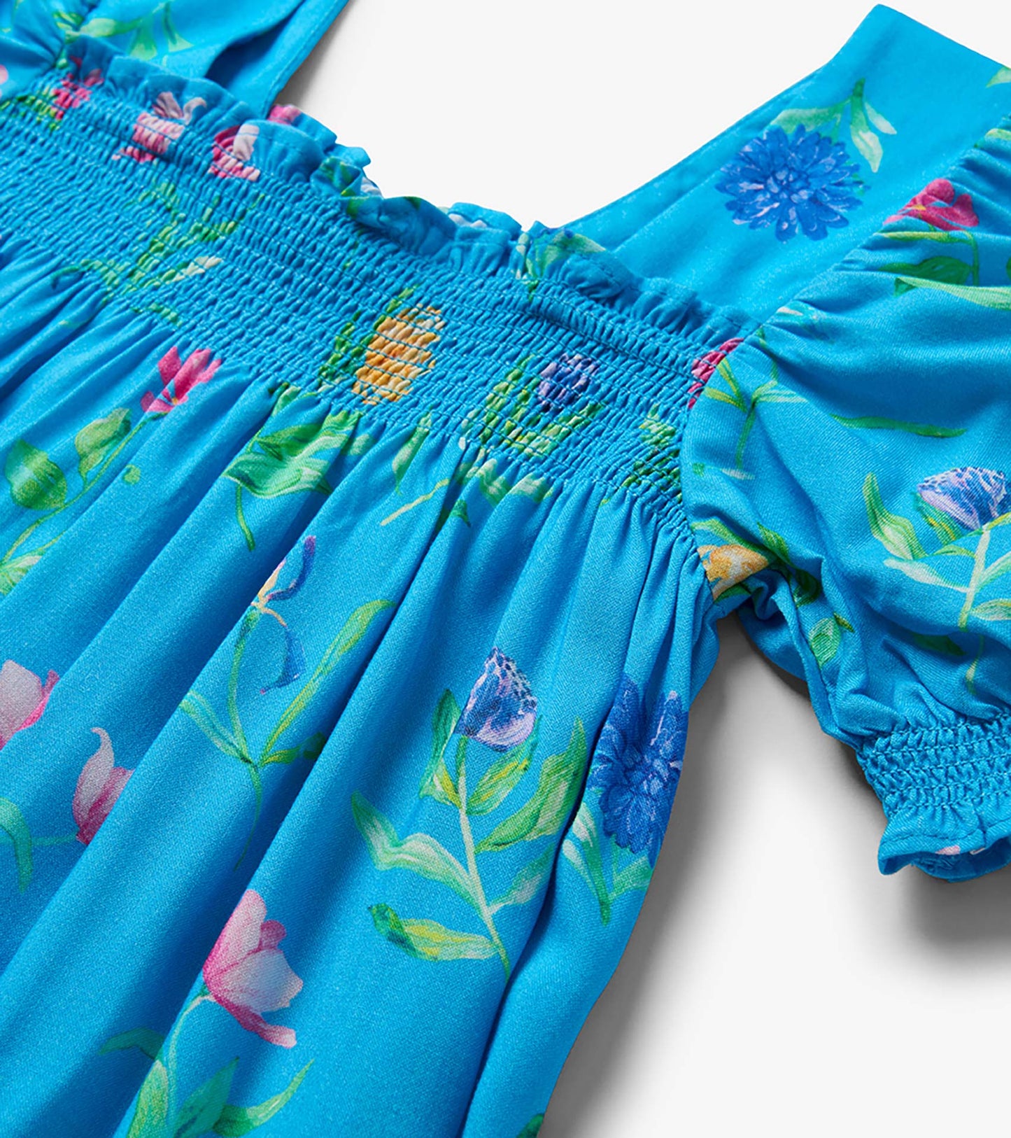 Blue floral girls dress with smocked waist, puff sleeves, and gathered skirt detail