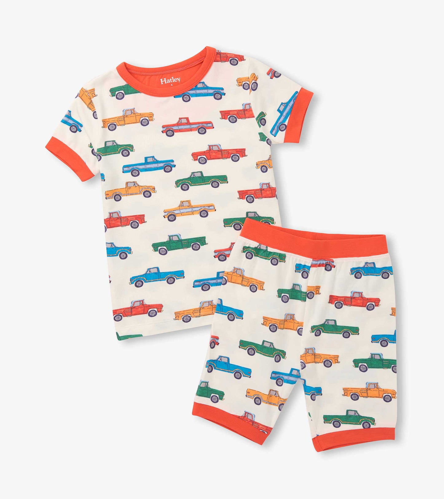 Cream boys short pajama set with colorful pickup truck print and bright orange trim, front view
