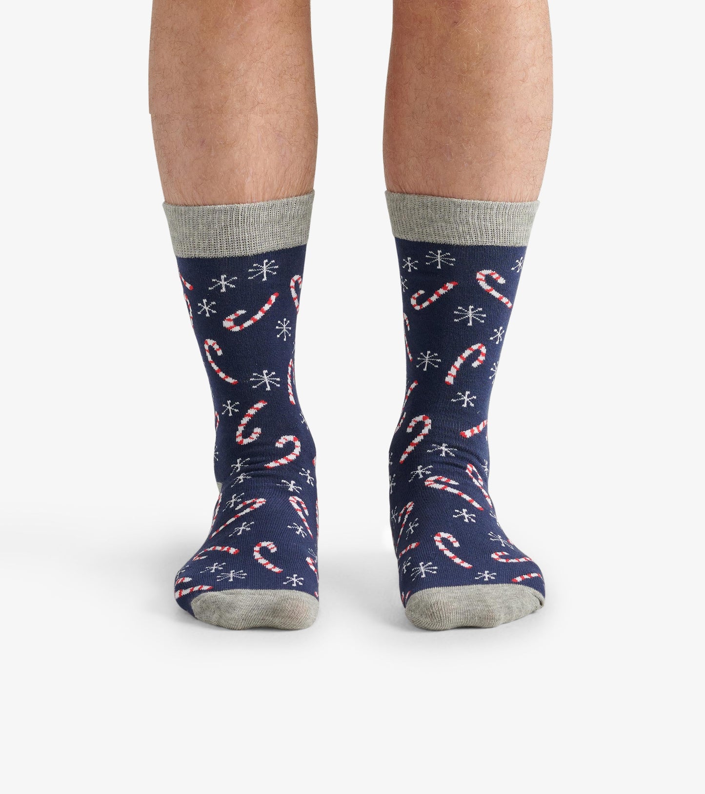 Navy crew socks featuring a candy cane pattern and snowflakes, with a light gray cuff and toe.