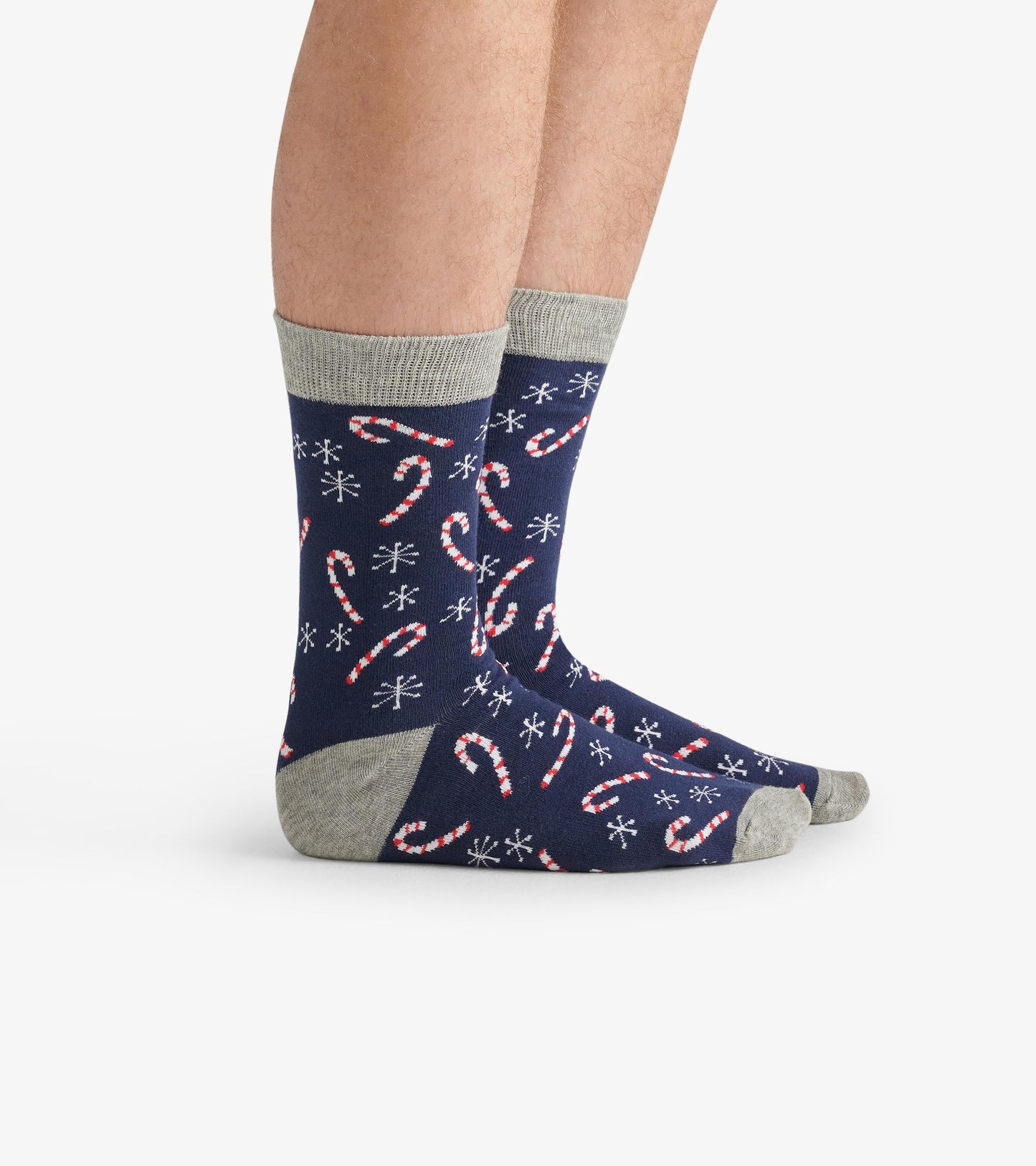Navy crew socks featuring a candy cane and snowflake pattern with a light gray cuff. One size fits most.