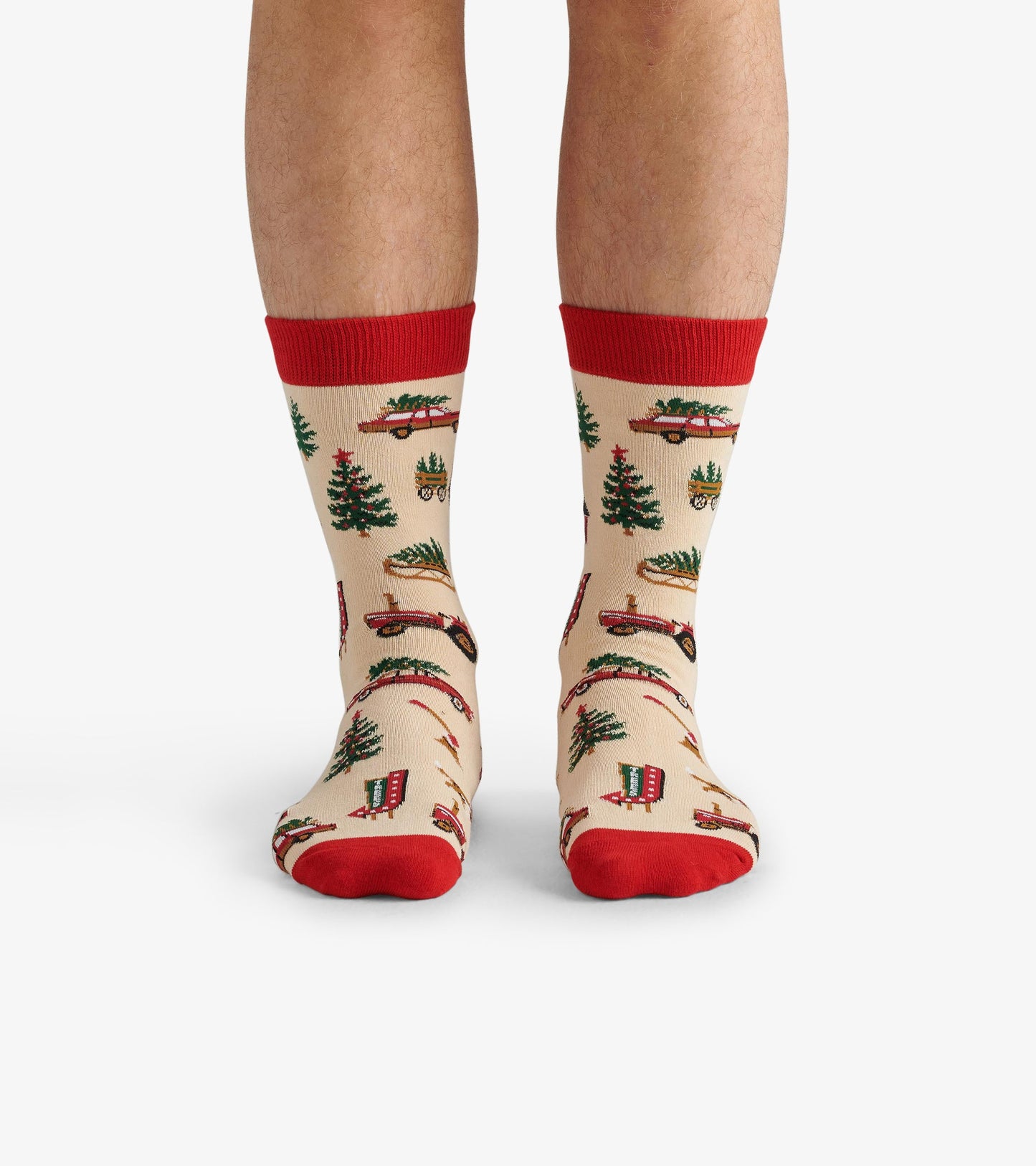 Beige crew socks with red cuffs, featuring a festive pattern of Christmas trees and vintage trucks.